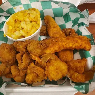 a basket of fried fish and macaroni and cheese