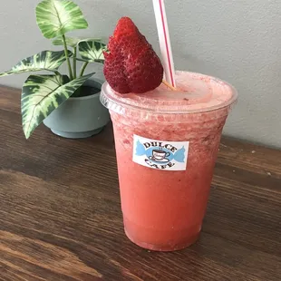 a strawberry drink with a straw