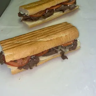 The steak Sandwich steak tomatoes onions and cheese.