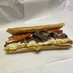 Special sandwich has steak,ham,egg,cheese,tomato,onions and mojo!