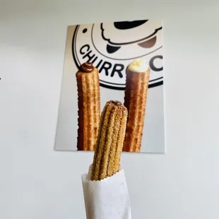 a hand holding churros