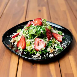 Quinoa arugula salad, with strawberries, grapes, walnuts, queso fresco and Italian zesty vinaigrette