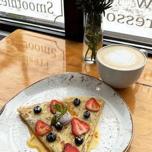 La sabrosa crepe, with mix berries cream cheese inside, orange vanilla coulis and fresh fruit