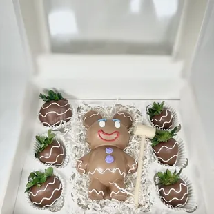 a chocolate teddy bear and strawberries