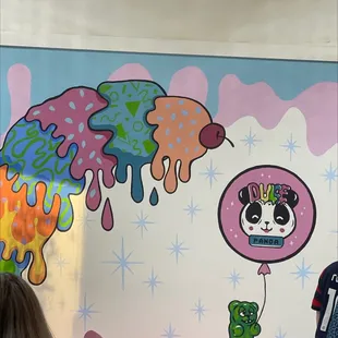 a panda holding a balloon