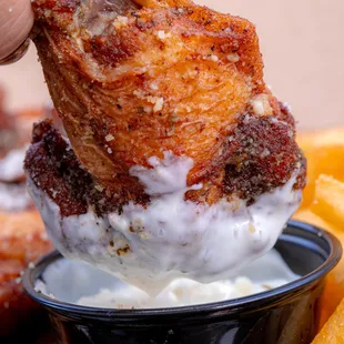 a person dipping something into a bowl