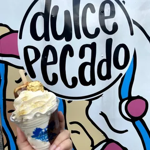 a hand holding an ice cream cone