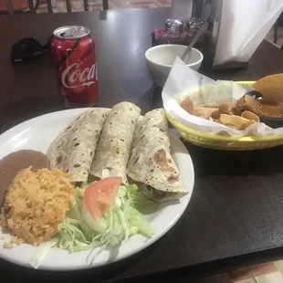 a plate of mexican food and a drink