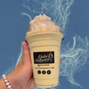 a hand holding a cup of coffee