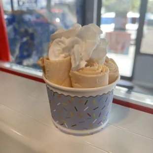 a cup of ice cream with whipped topping
