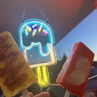 a person holding a popsicle