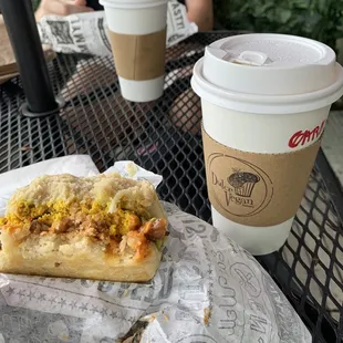 Egg &amp; bacon sandwich on a biscuit with a caramel oat latte.