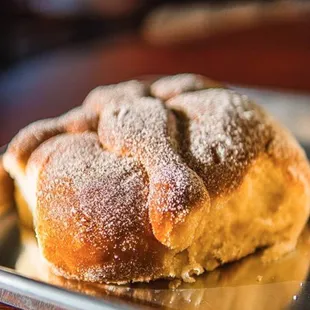 a pastry on a plate with powdered sugar