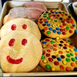 a tray of cookies with smiley faces