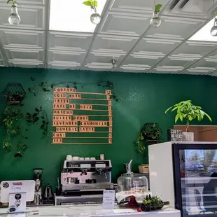 a coffee shop with a green wall