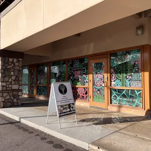 a sign in front of a coffee shop