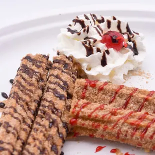 a plate of desserts with whipped cream and chocolate