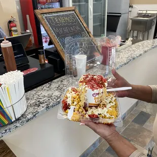 a woman holding a tray of food