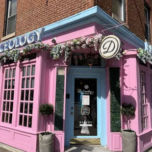 a pink building with a blue door