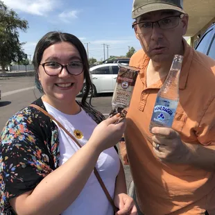 a woman holding a bottle of water