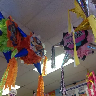 a bunch of pinatas hanging from the ceiling