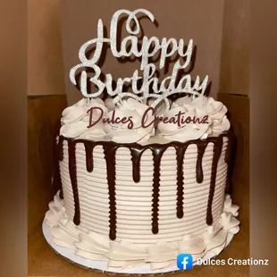 Cake on whipped cream frosting and chocolate drip