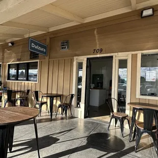 Outside covered patio on a warm afternoon. Some potted plants would make the space more cozy.