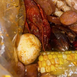 Crab legs, shrimp, sausage, mussels, eggs, corn, and potatoes!?