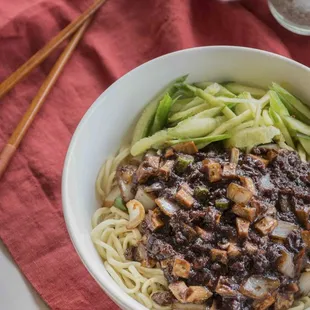 Bei Jing Bean Paste Noodle (aka Black Bean Noodle), freshly handmade noodle topped with stir-fried ground pork, soybean paste, & cucumbers.