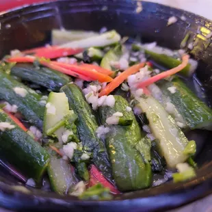 a bowl of pickled cucumbers and onions