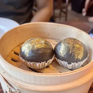 two dumplings in a wooden container
