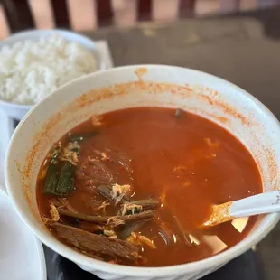 a bowl of soup and a plate of rice