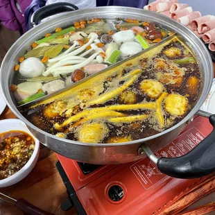 a hot pot of soup on a table