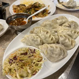 Lamb momo with some cabbage salad. Hand made, hot and drippy. Yummy! Not spicy unless you put that sauce on.