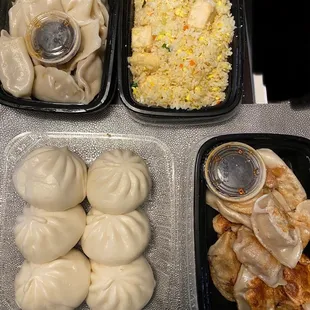 Pork and veggie dumplings (top left), veggie fried rice, bbq pork bao, and pork and chive potstickers  (bottom rt)