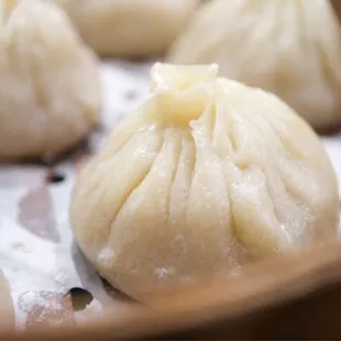 several dumplings in a wooden container