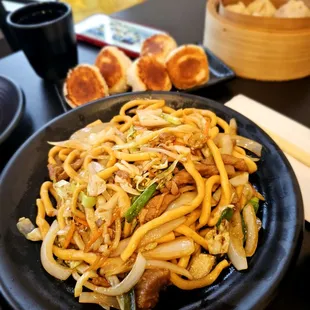 a plate of noodles with meat and vegetables