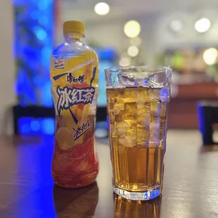 a drink and a bottle of drink on a table