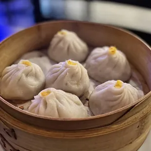 a wooden basket filled with dumplings