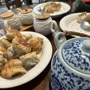 a plate of dumplings and a teapot