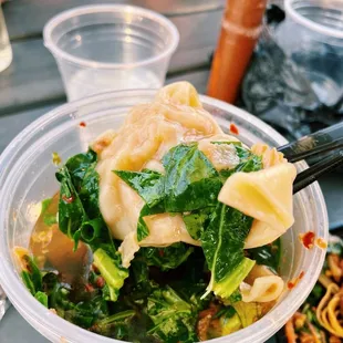 a bowl of noodles and broccoli