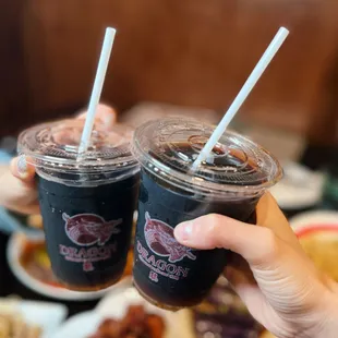 wo people holding drinks