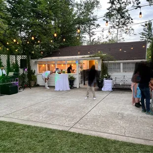 Dance floor, bartending/drink service and entryway to where food/buffet can be set up