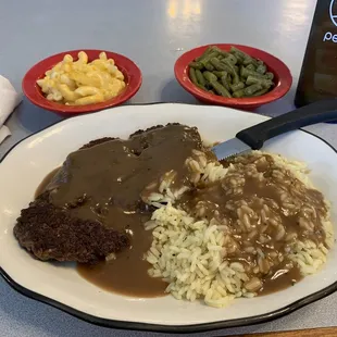 Tuesday's hamburger steak and gravy with rice, mac 'n' cheese and green beans.