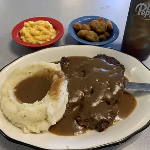 Hamburger steak and mashed potatoes, mac 'n' cheese and fried okra.