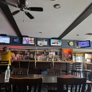a bar with several televisions on the wall