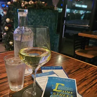 a glass of wine and a menu