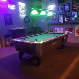 a pool table and neon lights