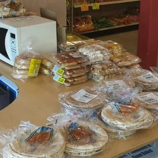 a counter with a variety of breads