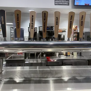  a row of beer taps in a bar